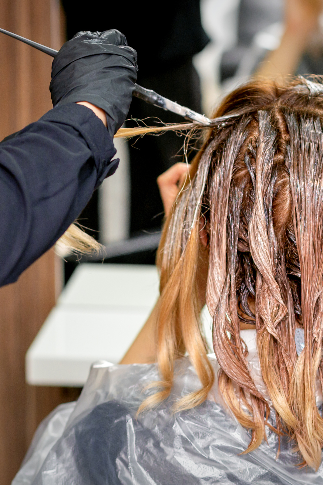 Hairdresser's Hand Coloring Female Hair